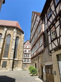 Low angle view of buildings against clear blue sky