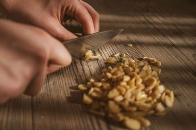 Close-up of person chopping nuts