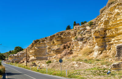 View of mountain road against blue sky