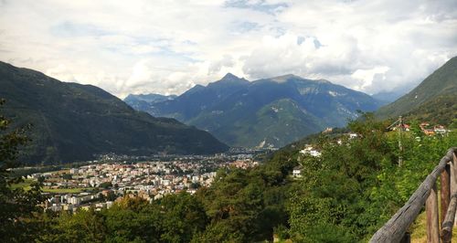 Scenic view of townscape and mountains against sky