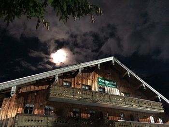 Low angle view of illuminated building against sky at night