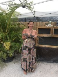 Portrait of smiling young woman standing outdoors