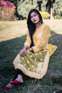 Beautiful young woman sitting outdoors