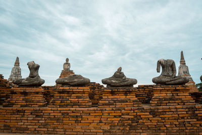 Statue of temple against cloudy sky