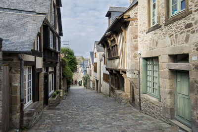Cobbled street in dinan, brittany, france with medieval houses either side