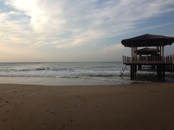 Scenic view of beach against sky during sunset