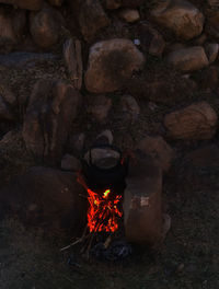 High angle view of bonfire on rock