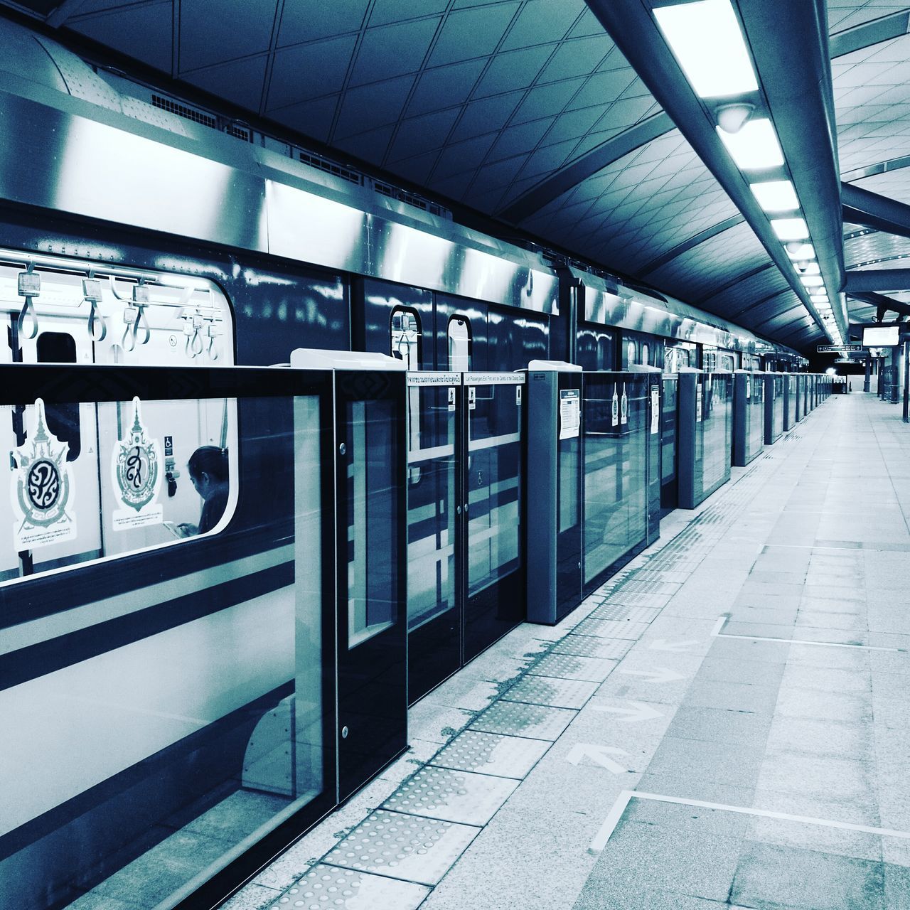 TRAIN ON RAILROAD STATION PLATFORM