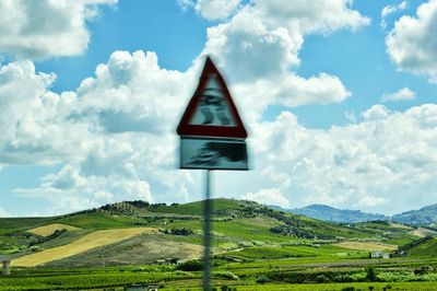 Scenic view of landscape against cloudy sky