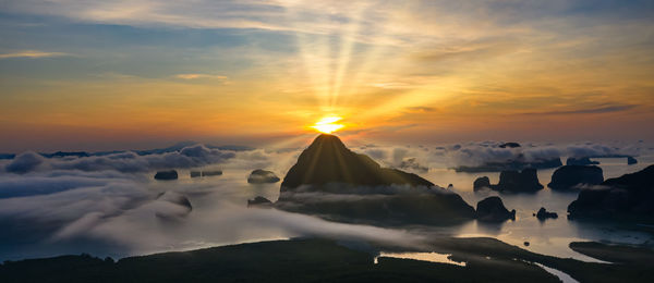 Aerial view, panorama landscape limestone and morning mist and the sunrise with blue sky background 