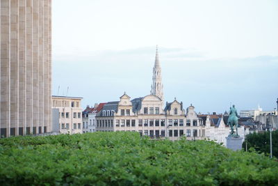Grand place against sky in city