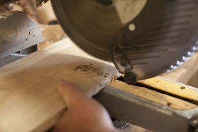 Close-up of hand working on wood