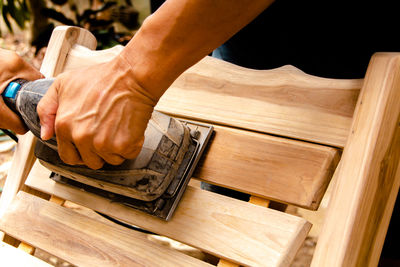 Close-up of hand working on wood