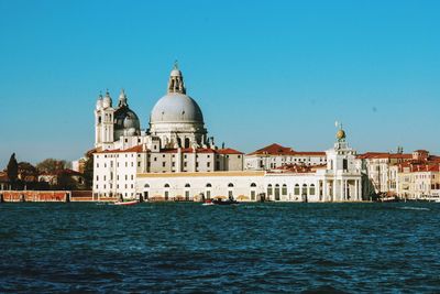 View of buildings against clear blue sky