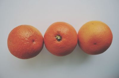 Close-up of red fruit over white background