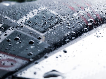 Close-up of raindrops on car windshield