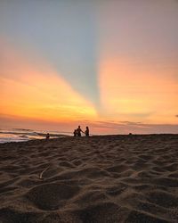 Scenic view of beach against sky during sunset