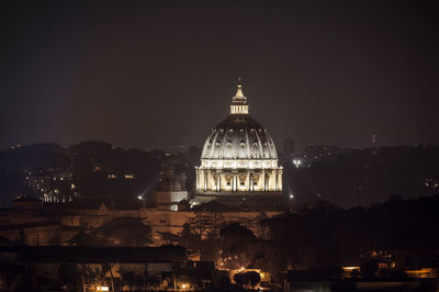 Illuminated san pietro in vatican city against sky at night