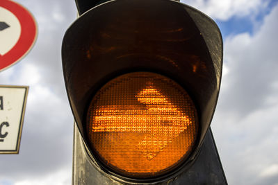 Low angle view of road signal against sky