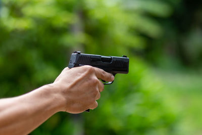 Close-up of man holding gun