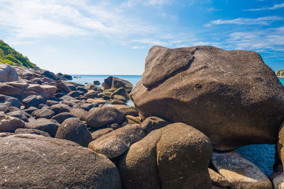 Rocks on beach against sky