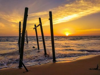 Scenic view of beach against sky during sunset