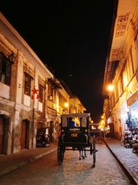 People in illuminated city at night