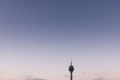 Low angle view of communications tower against sky