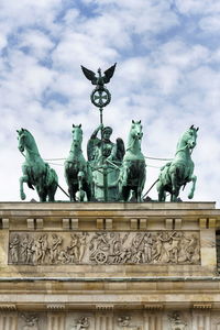 Low angle view of statue against cloudy sky