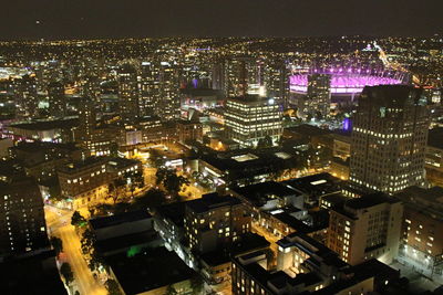 High angle view of city lit up at night