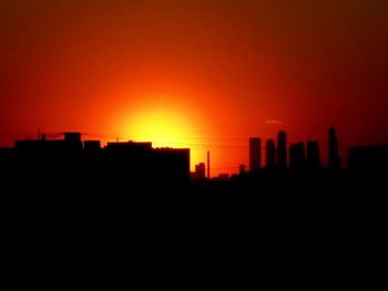 Silhouette of built structures at sunset