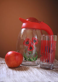 Close-up of fruits in glass vase on table