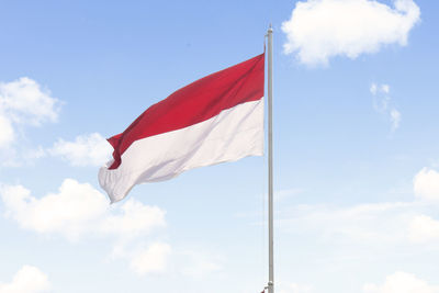 Low angle view of flag against sky