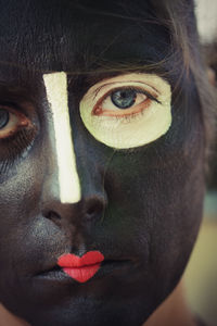 Close-up portrait of woman with face paint