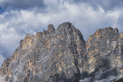 Low angle view of rocky mountain against sky