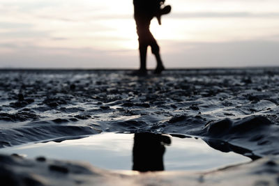 Low section of silhouette person on beach