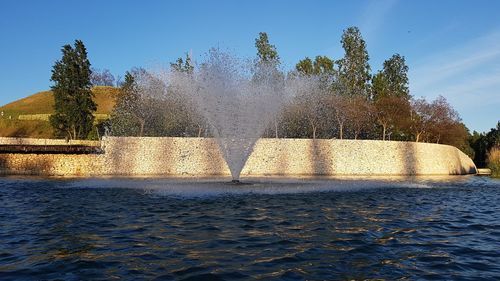 Fountain in park against sky