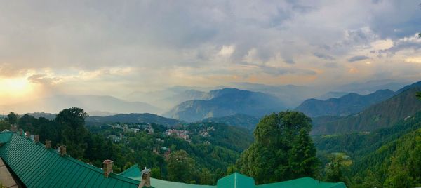 Panoramic view of trees and mountains against sky