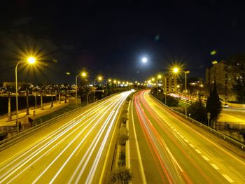 Light trails on road in city at night