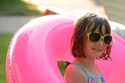 Portrait of young woman wearing sunglasses against sky