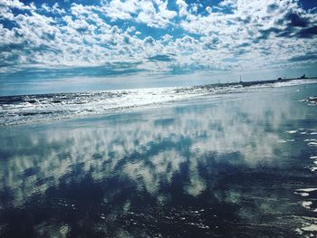 Scenic view of sea against cloudy sky