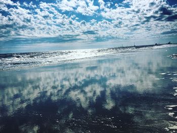 Scenic view of sea against cloudy sky