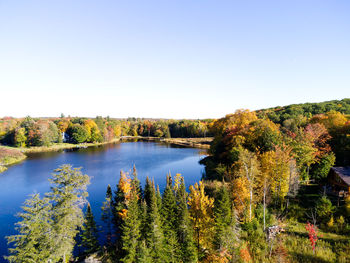 Scenic view of lake against clear sky during autumn