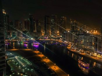 High angle view of city lit up at night