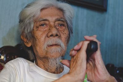 Close-up portrait of man using mobile phone