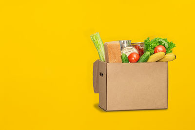 Red bell peppers on yellow container