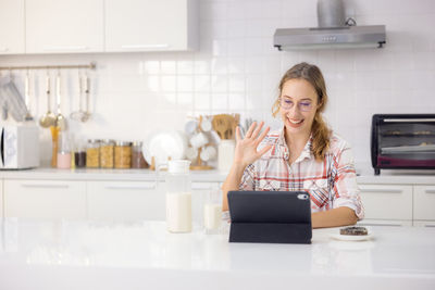 Portrait of smiling young woman using smart phone