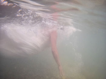 Low section of woman swimming in sea