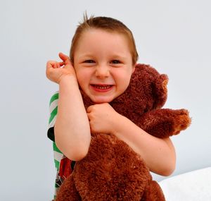 Portrait of smiling boy against white background