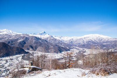 Snowcapped mountains against blue sky